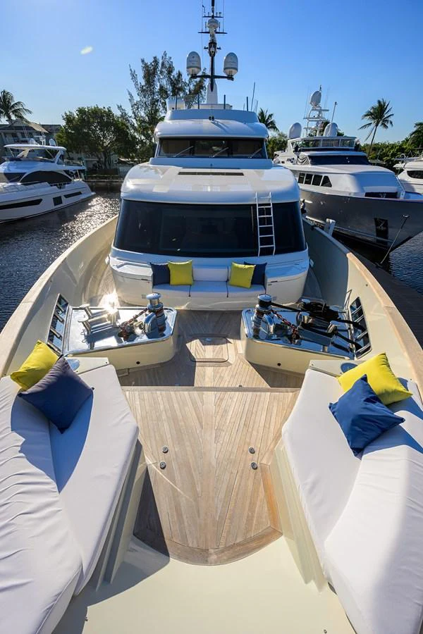 The yacht's foredeck features comfortable seating with colorful cushions, perfect for relaxation. aboard CHRISTINA Yacht for Sale