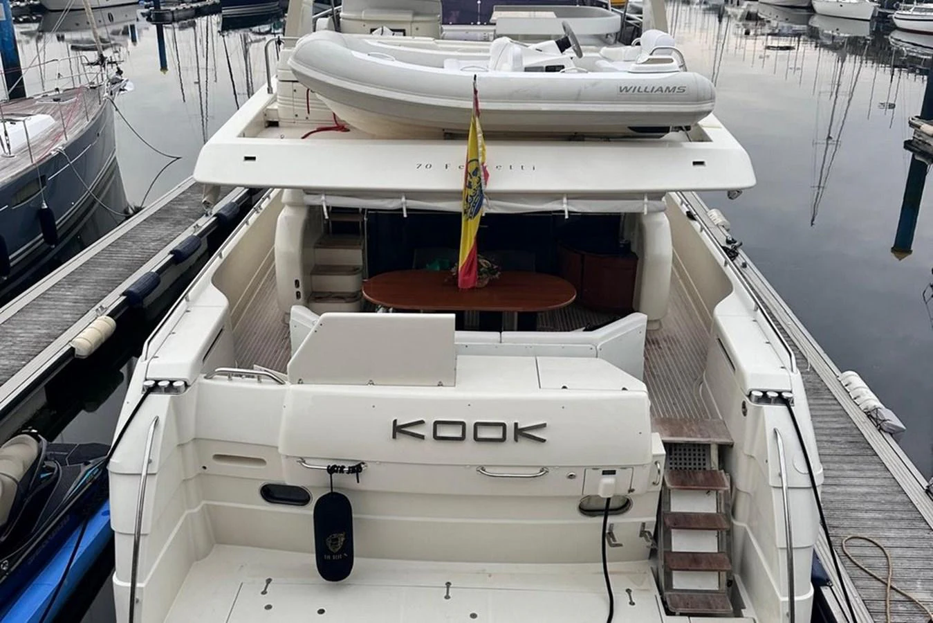The yacht's aft deck features a spacious layout with a tender on the upper deck and easy access to the water. aboard FERRETTI 70 Yacht for Sale
