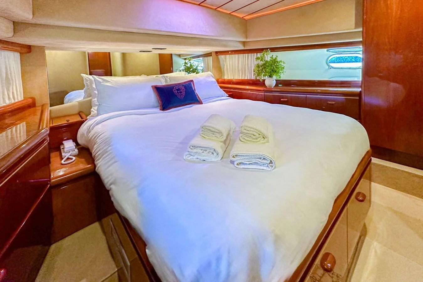 The stateroom features a plush bed with elegant wood finishes and soft lighting. aboard FERRETTI 70 Yacht for Sale