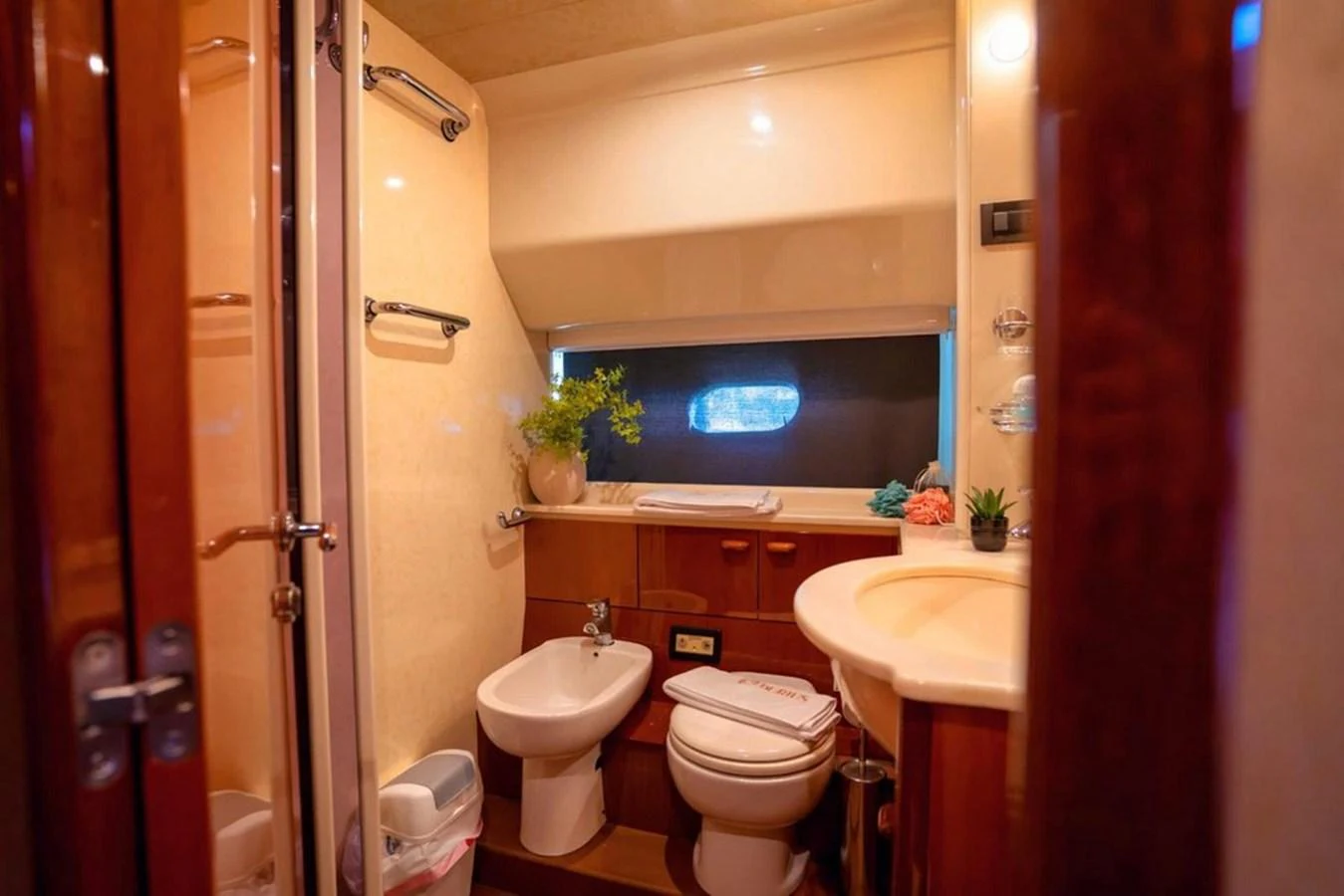 The yacht's bathroom features elegant wood finishes and modern amenities. aboard FERRETTI 70 Yacht for Sale