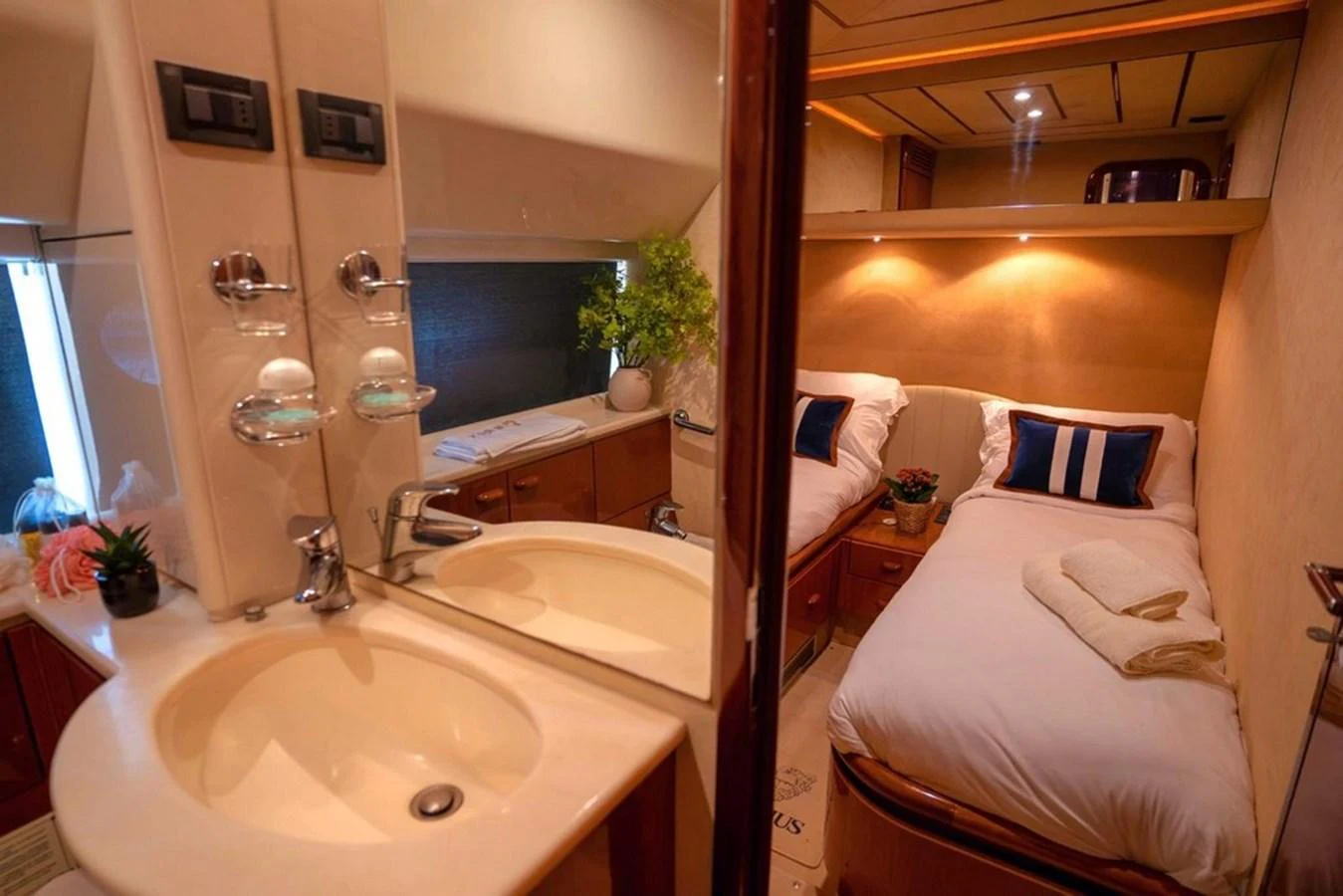 A cozy guest stateroom featuring twin beds and a well-appointed vanity area. aboard FERRETTI 70 Yacht for Sale