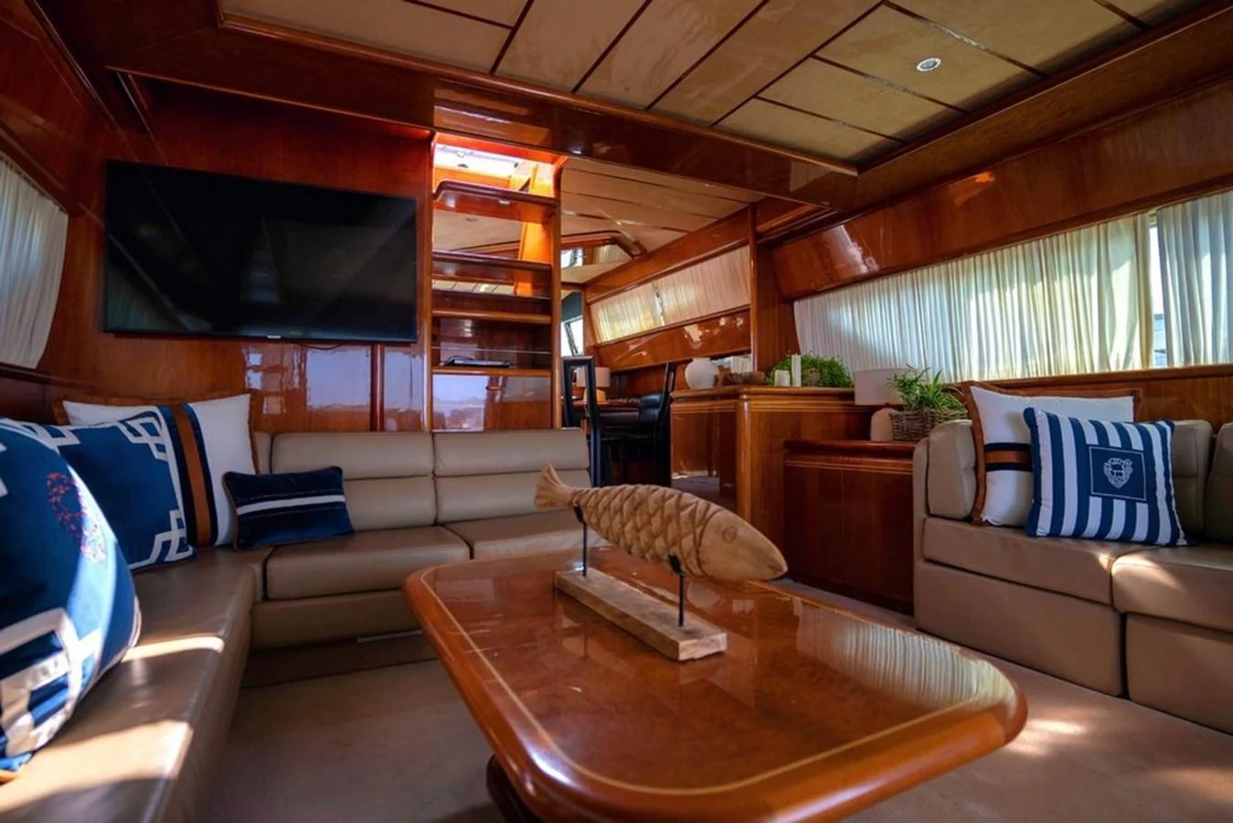 The yacht's interior features a cozy and elegant lounge area with plush seating and tasteful decor. aboard FERRETTI 70 Yacht for Sale