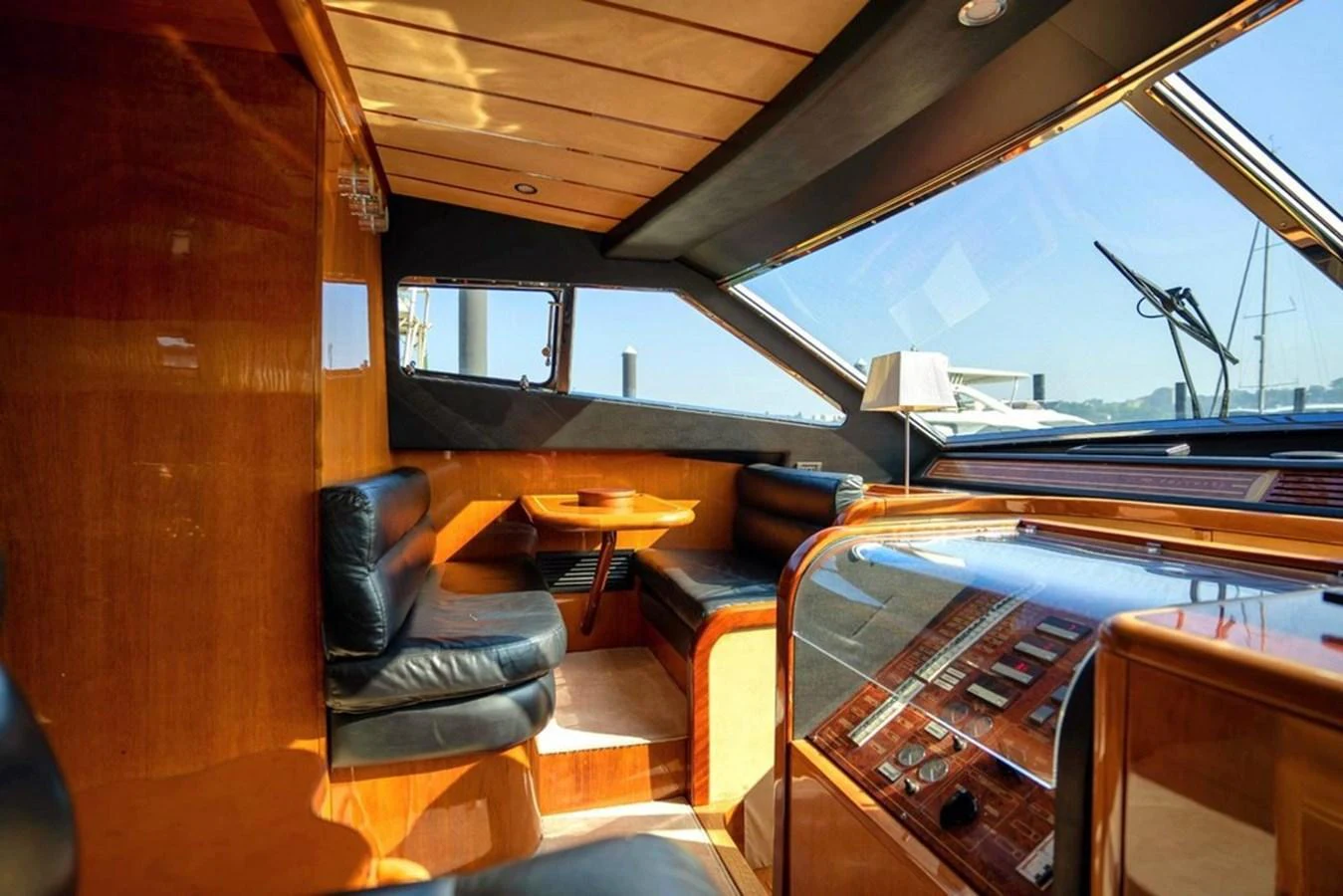 The yacht's saloon features luxurious leather seating and polished wood finishes, offering a comfortable and stylish space for relaxation. aboard FERRETTI 70 Yacht for Sale