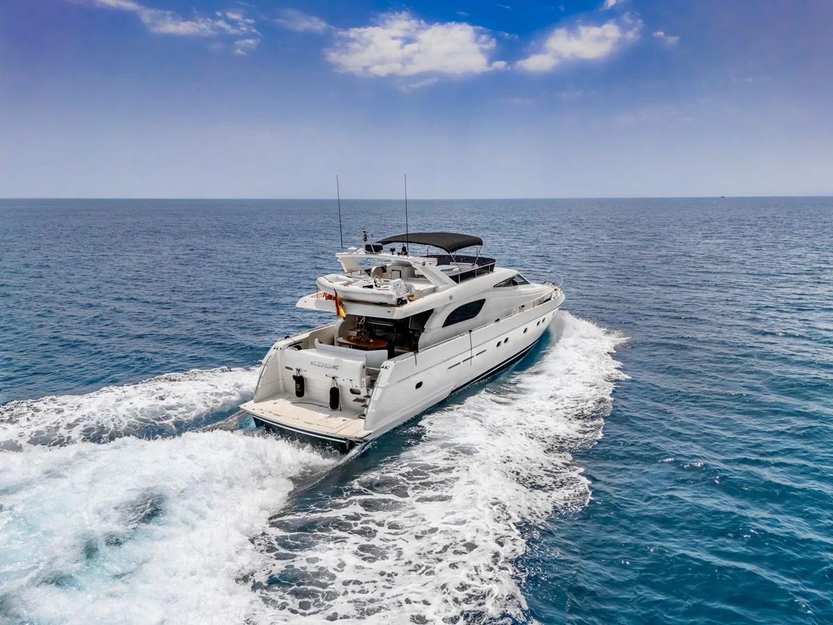 A sleek yacht cruises through open waters under a clear blue sky. aboard FERRETTI 70 Yacht for Sale
