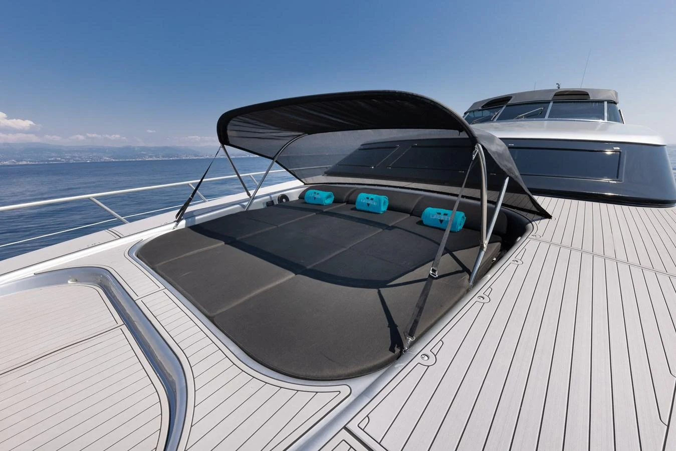 The foredeck features a spacious sunbathing area with a retractable canopy for shade. aboard LAUREN V Yacht for Sale