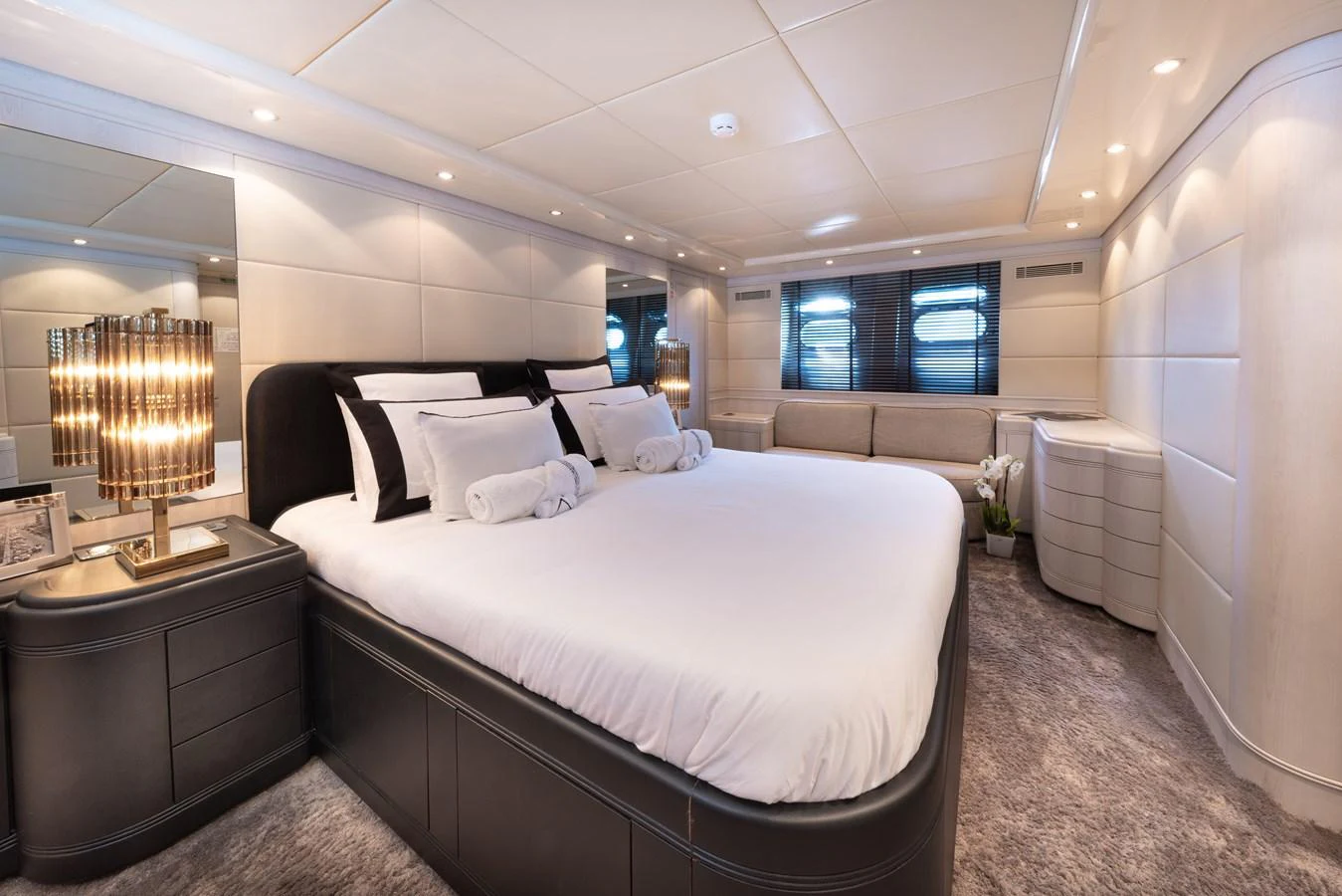 The master stateroom features a luxurious king-sized bed with elegant furnishings and soft lighting. aboard LAUREN V Yacht for Sale