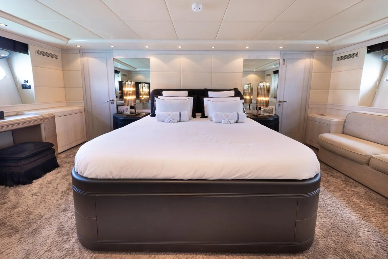 The master stateroom features a luxurious bed with elegant decor and ample natural light. aboard LAUREN V Yacht for Sale