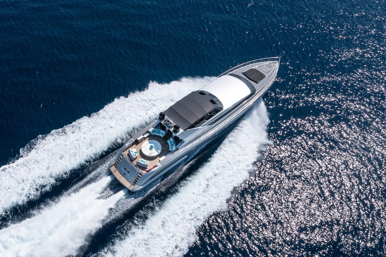 A sleek and modern yacht cruises swiftly through the open sea, leaving a trail of white water in its wake. aboard LAUREN V Yacht for Sale