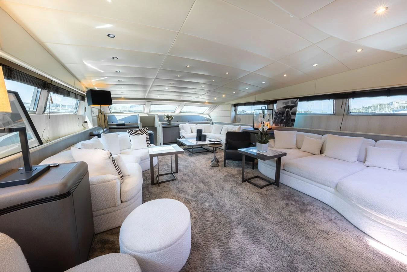 The spacious salon features elegant seating and large windows for panoramic views. aboard LAUREN V Yacht for Sale