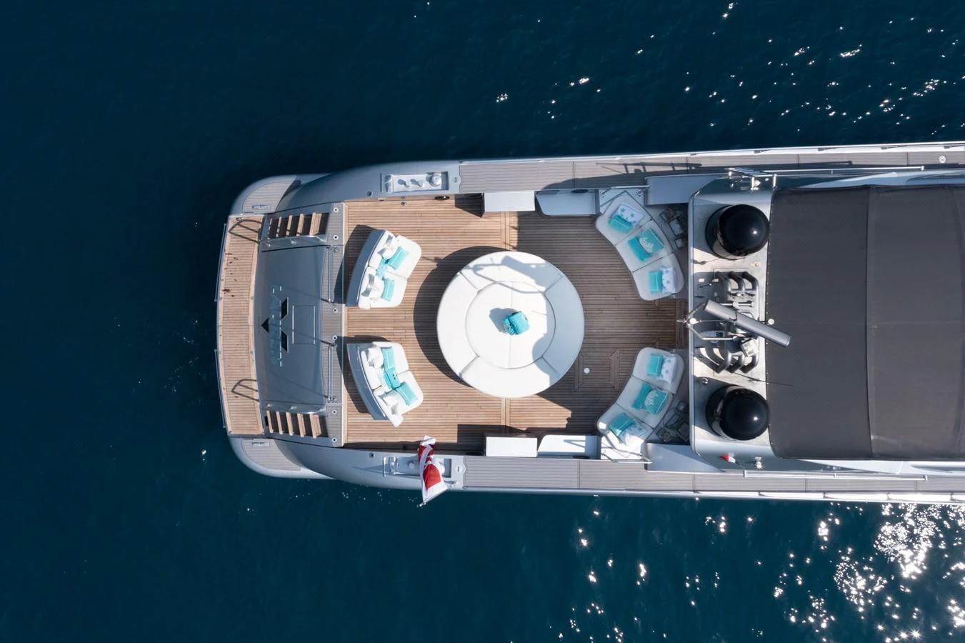 The sundeck features a circular seating area with plush cushions, perfect for relaxation and socializing. aboard LAUREN V Yacht for Sale