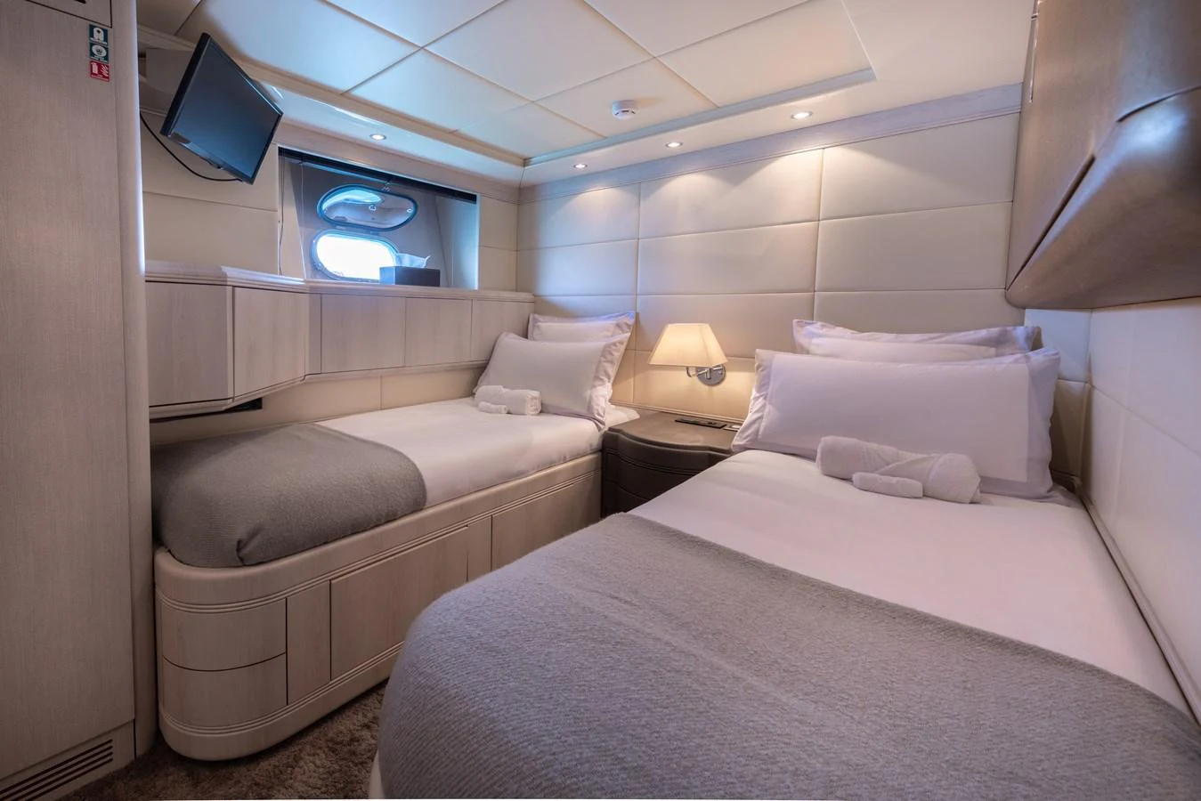 The guest stateroom features twin beds with plush bedding and a cozy ambiance. aboard LAUREN V Yacht for Sale