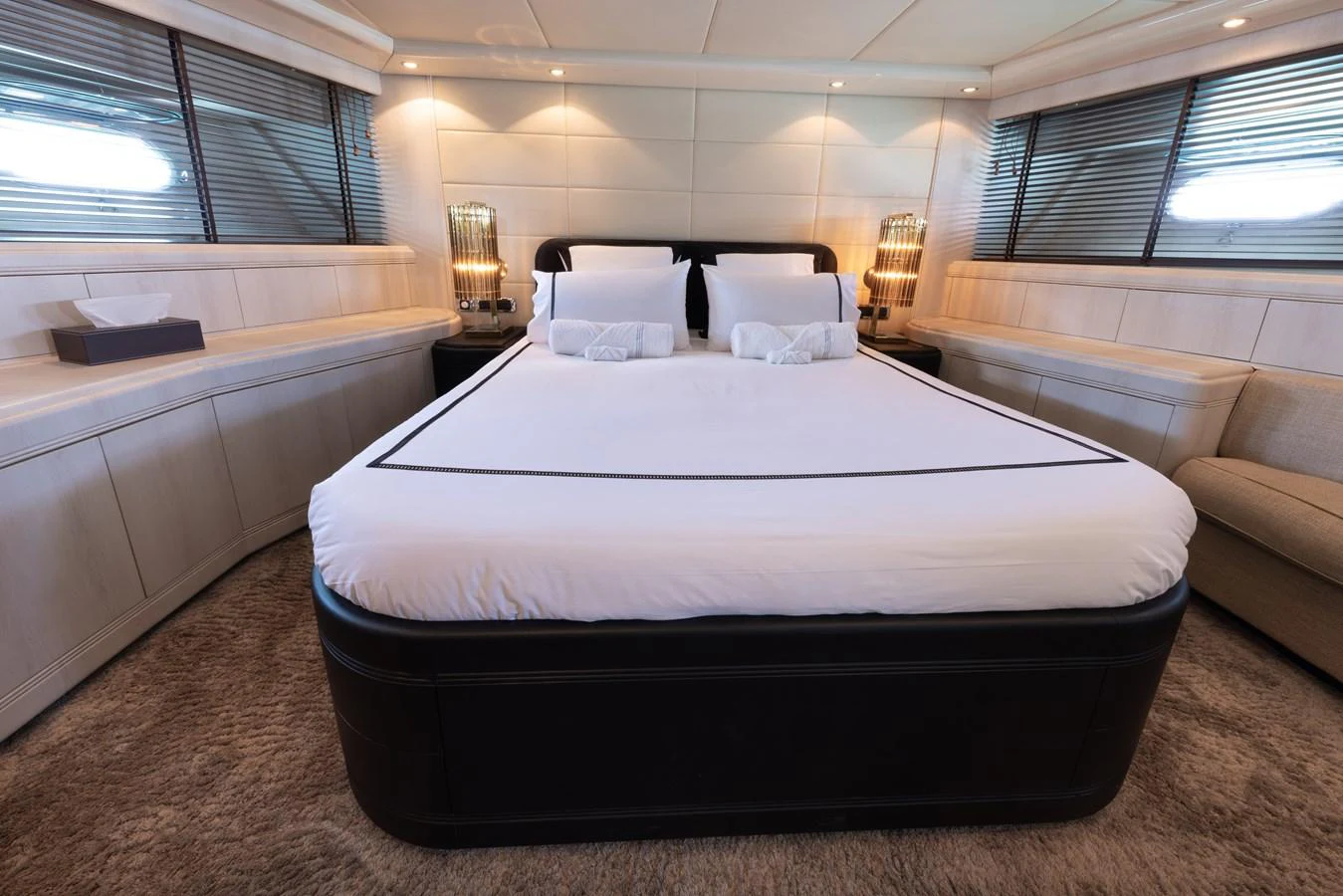 The master stateroom features a luxurious bed with elegant bedding and ambient lighting. aboard LAUREN V Yacht for Sale