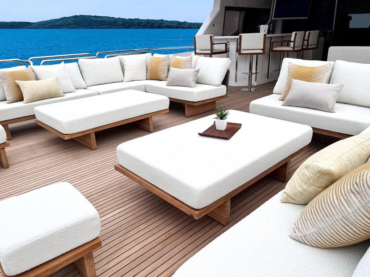 The aft deck features luxurious white cushioned seating with a stunning ocean view. aboard HORIZON FD90 Yacht for Sale