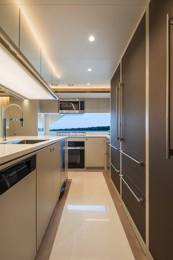 The galley features modern appliances and sleek design, perfect for gourmet cooking at sea. aboard HORIZON FD90 Yacht for Sale