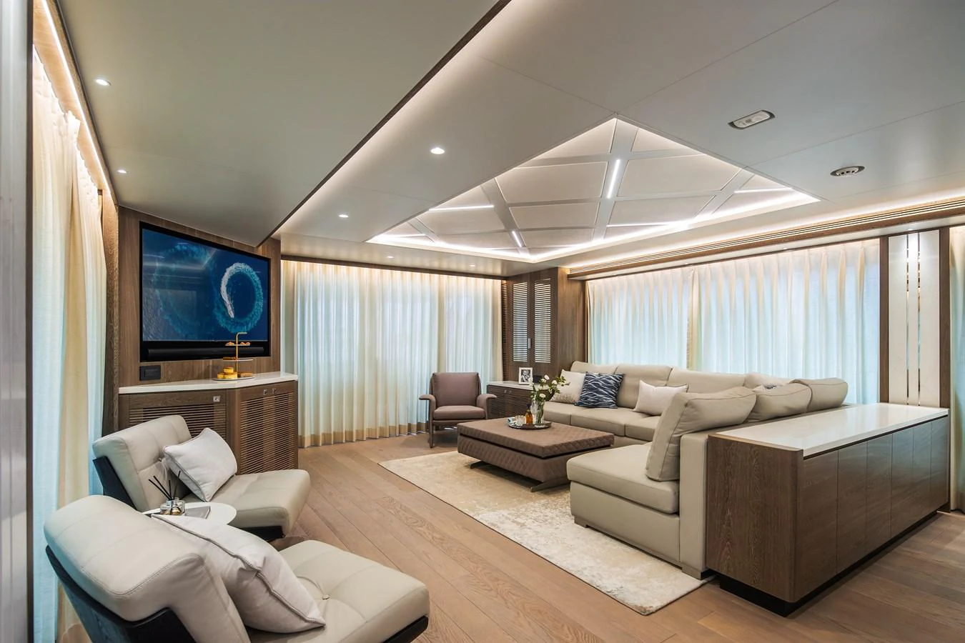 The salon features a spacious and elegantly designed seating area with modern furnishings and ambient lighting. aboard HORIZON FD90 Yacht for Sale
