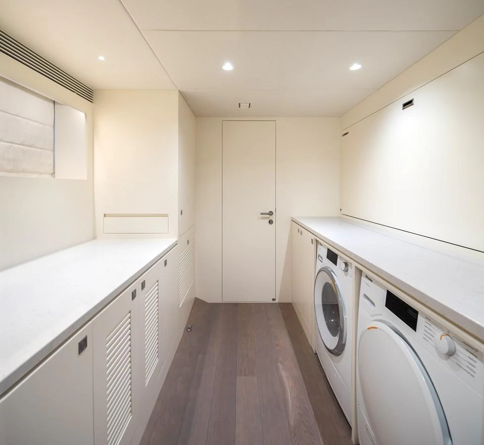 The yacht features a well-equipped laundry room with modern appliances and ample counter space. aboard HORIZON FD90 Yacht for Sale