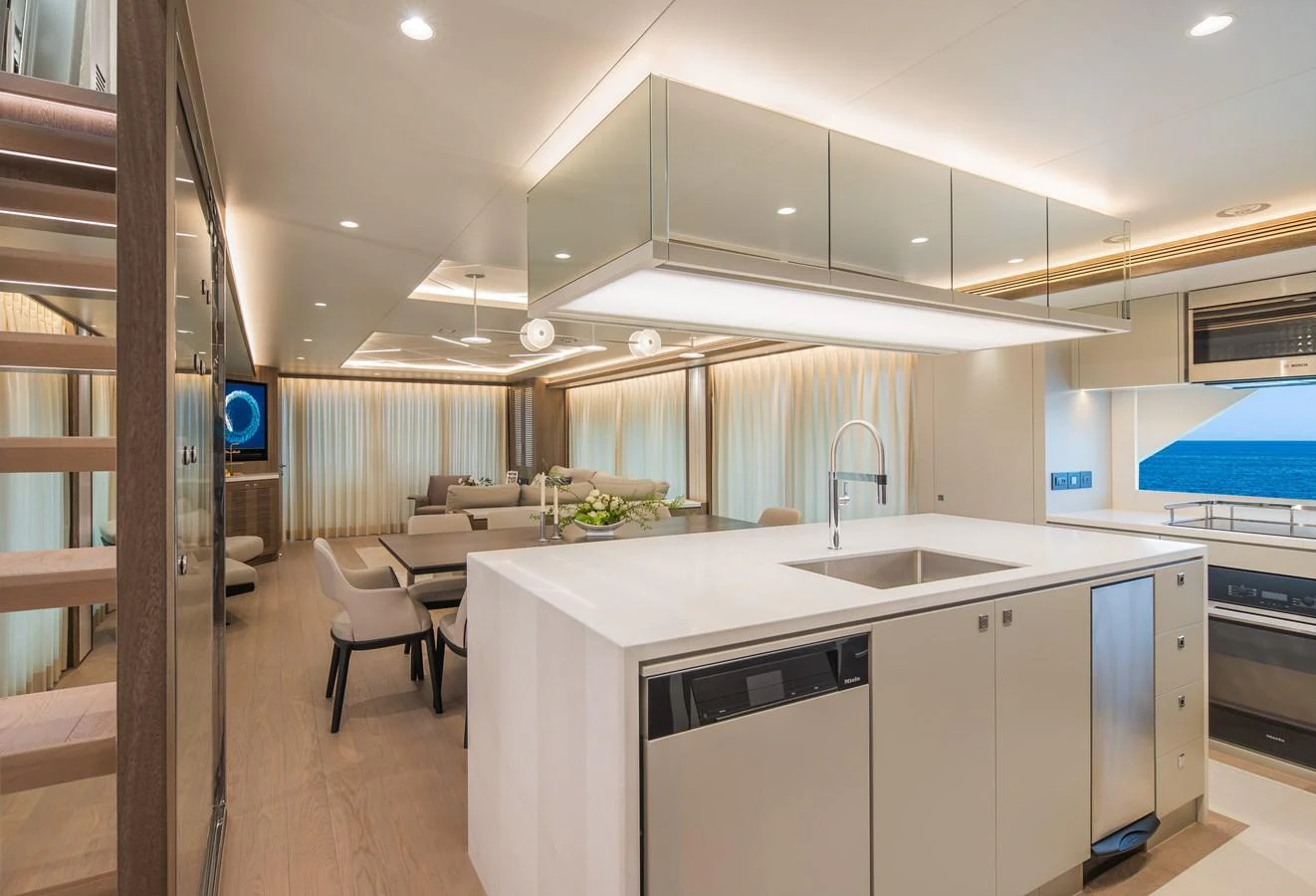The yacht's galley features a modern design with a spacious island and high-end appliances. aboard HORIZON FD90 Yacht for Sale