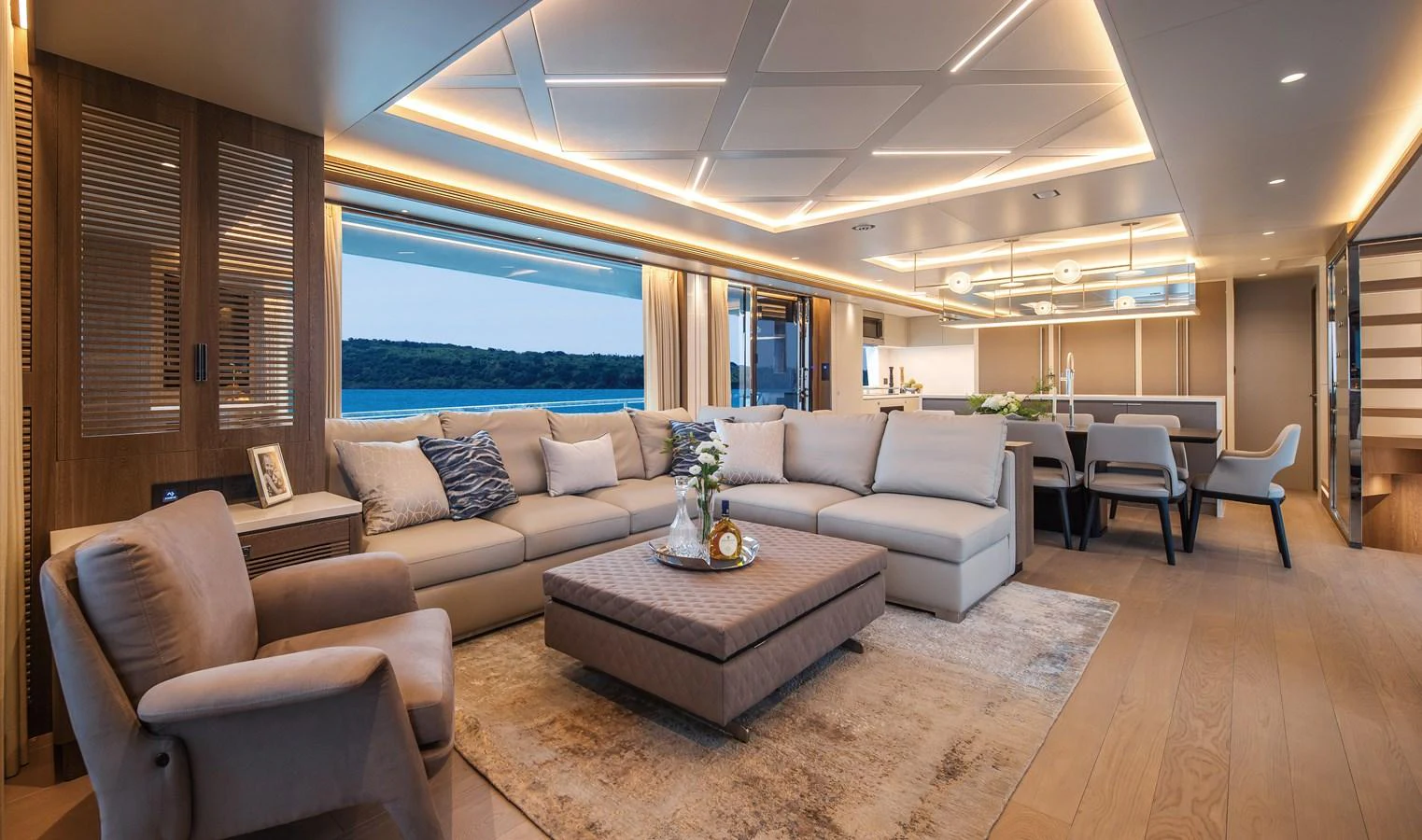 The yacht's salon features a spacious and elegantly designed seating area with modern furnishings and ambient lighting. aboard HORIZON FD90 Yacht for Sale
