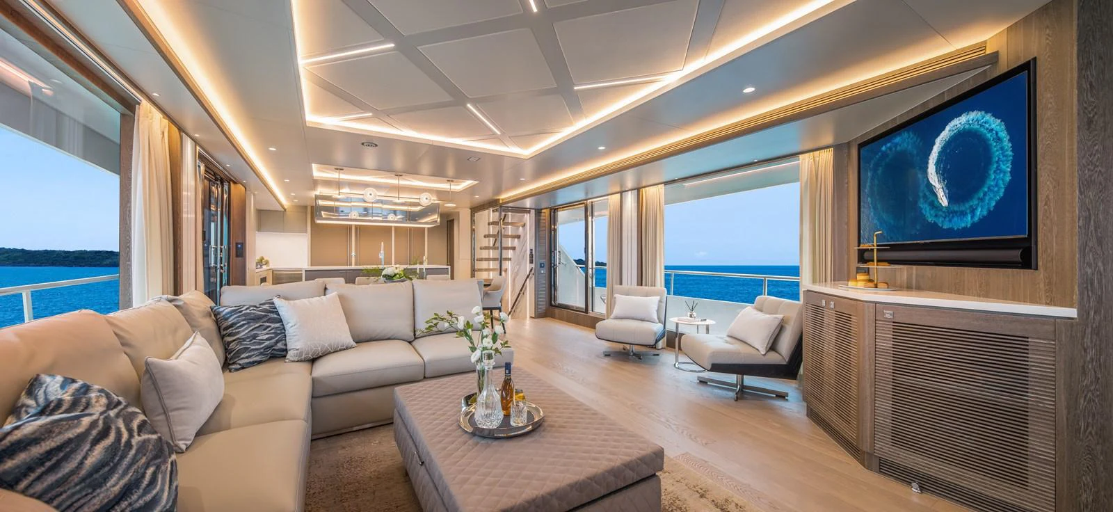 The spacious salon features elegant seating, modern lighting, and panoramic ocean views. aboard HORIZON FD90 Yacht for Sale