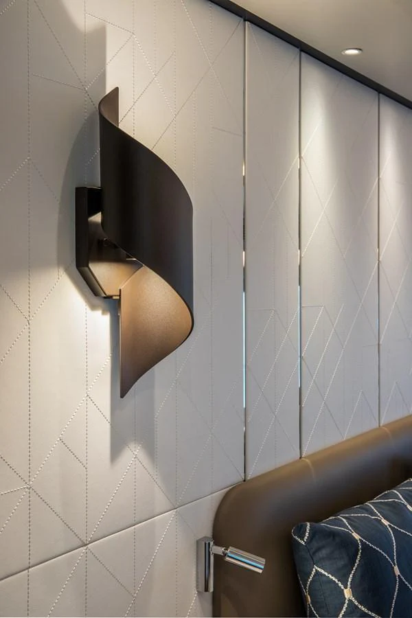 A stylish wall light fixture illuminates a modern and elegant interior space. aboard HORIZON FD90 Yacht for Sale
