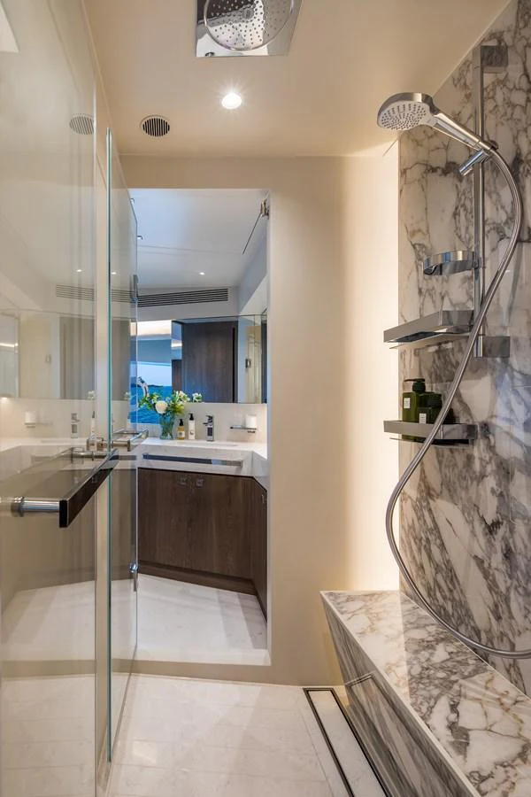 The yacht's bathroom features elegant marble accents and modern fixtures, creating a luxurious and serene atmosphere. aboard HORIZON FD90 Yacht for Sale