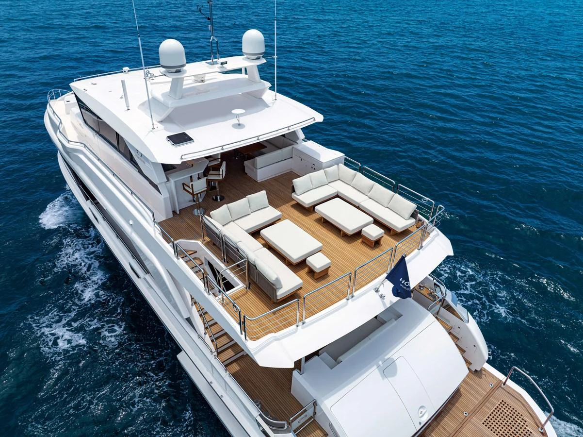 The yacht's spacious aft deck features luxurious seating and a stunning view of the open sea. aboard HORIZON FD90 Yacht for Sale