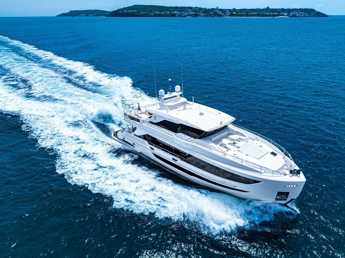 A sleek yacht cruises through vibrant blue waters, showcasing its modern design and powerful performance. aboard HORIZON FD90 Yacht for Sale