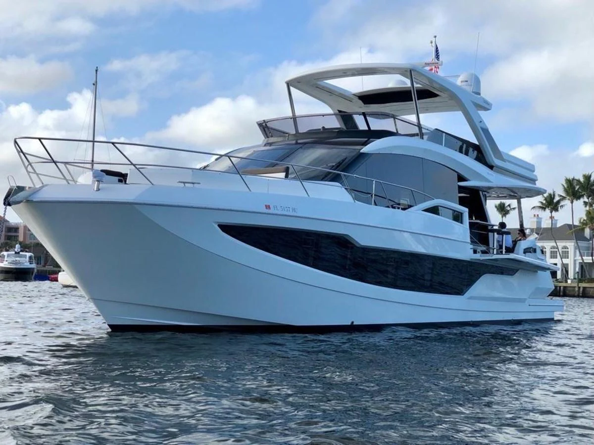 A sleek and modern yacht glides gracefully on the water, showcasing its stylish design and spacious decks. aboard GODSPEED Yacht for Sale