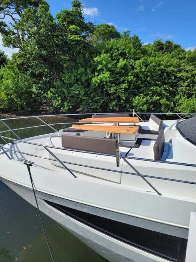 The foredeck features a stylish seating area with tables, perfect for enjoying the view. aboard GODSPEED Yacht for Sale