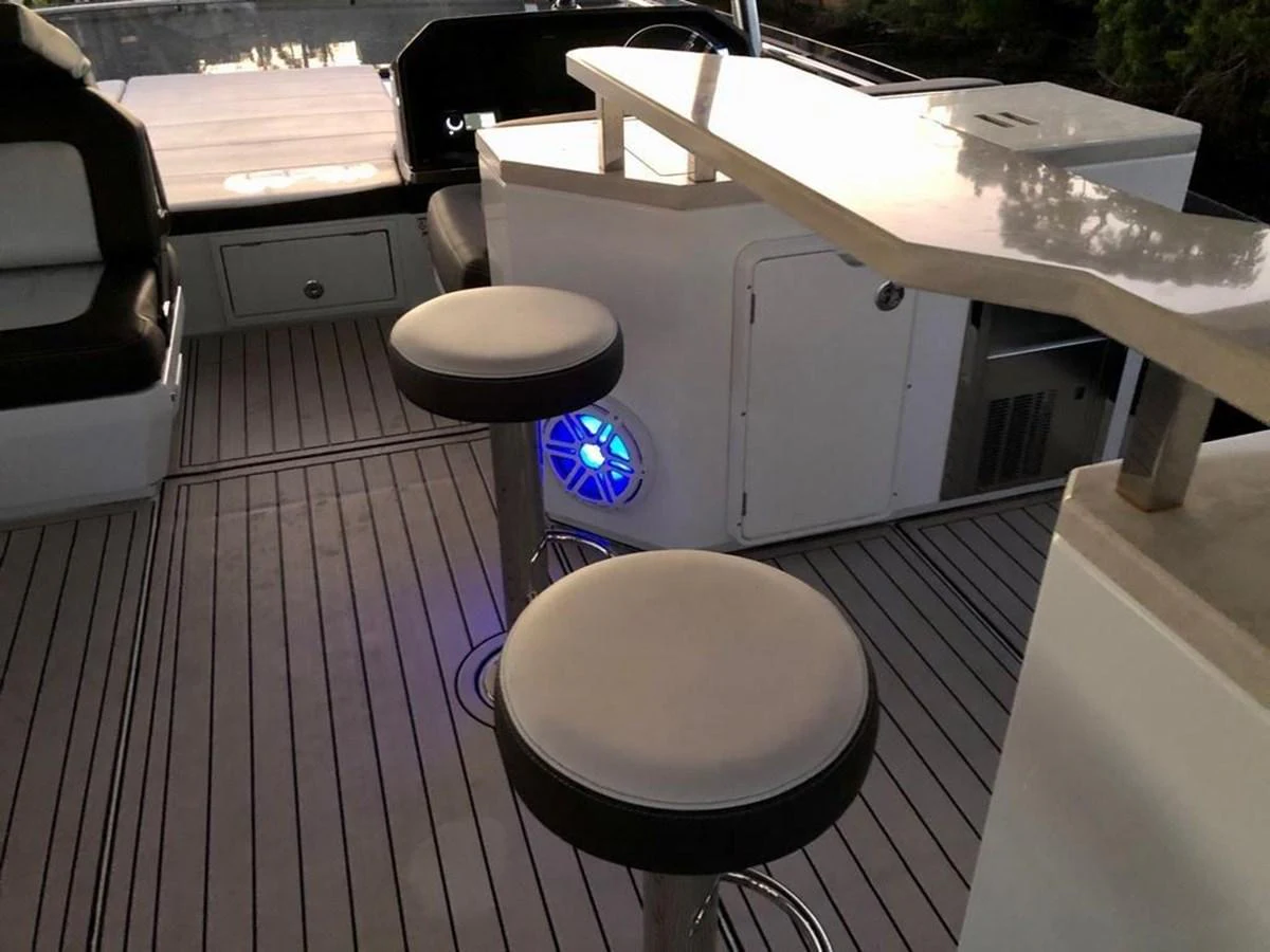 The cockpit area features sleek bar stools and modern lighting, creating a stylish and inviting atmosphere. aboard GODSPEED Yacht for Sale