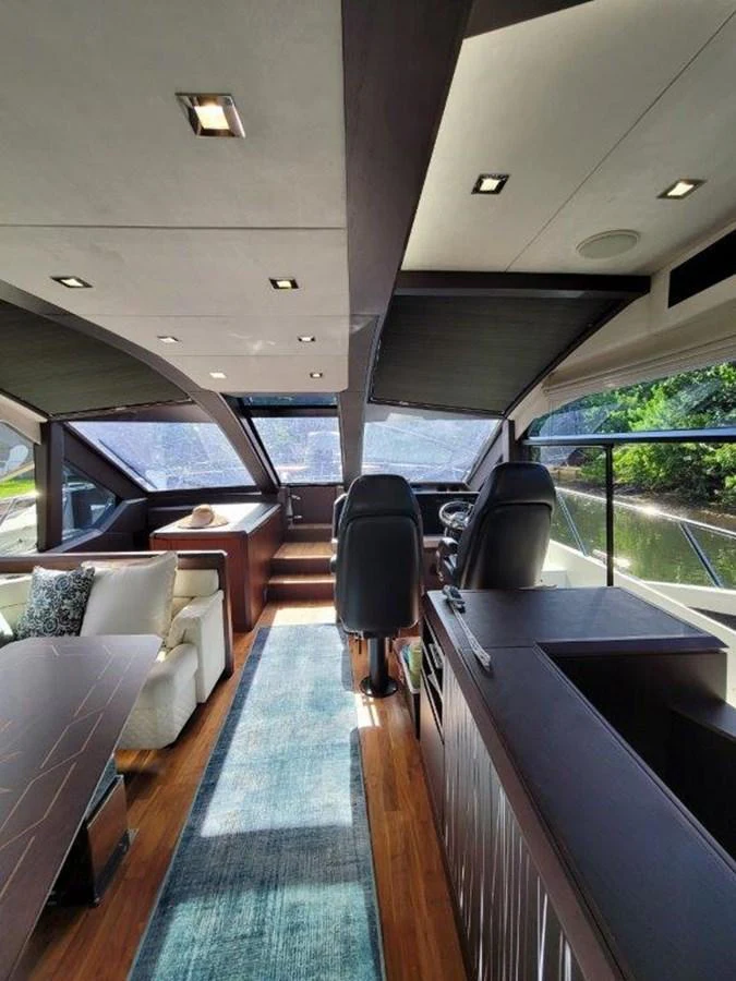 The salon features a spacious and modern design with ample natural light and luxurious seating. aboard GODSPEED Yacht for Sale