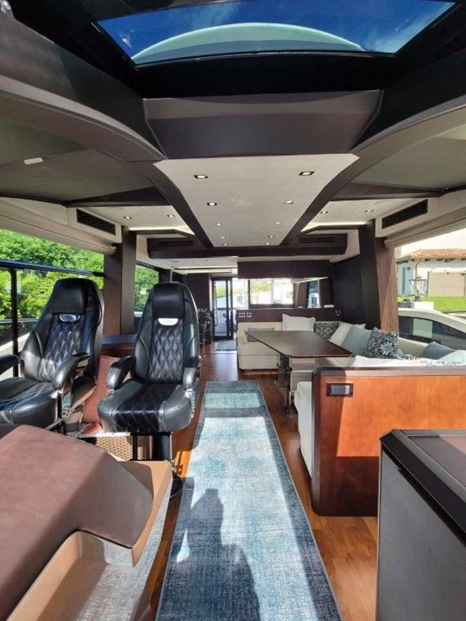 The yacht's salon features luxurious seating, a skylight, and modern decor. aboard GODSPEED Yacht for Sale