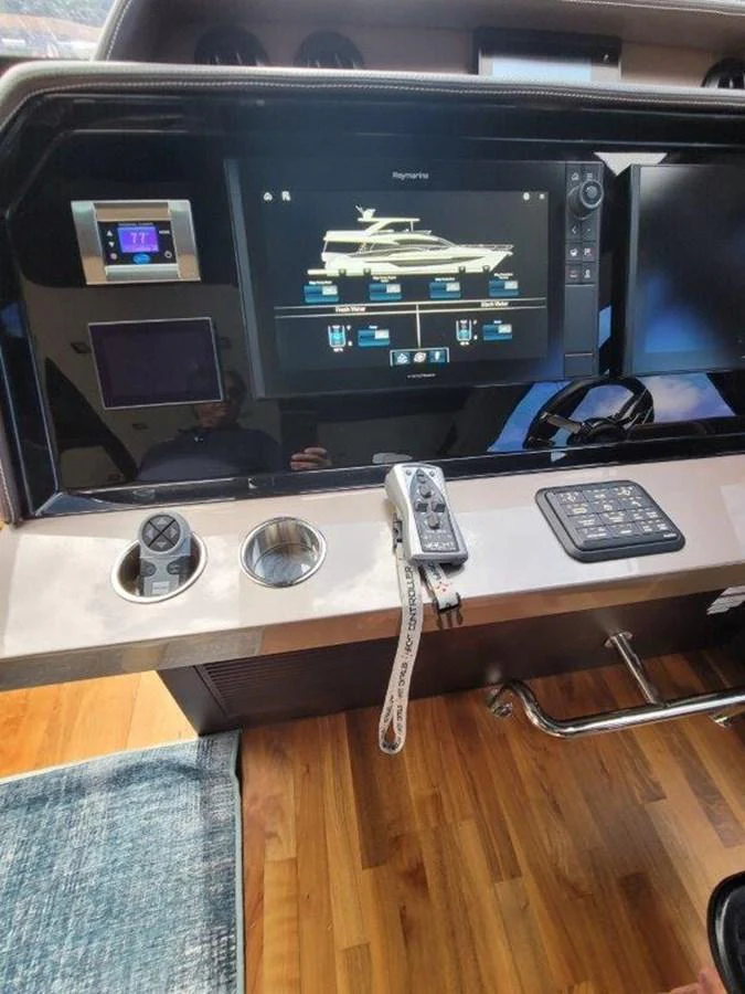 The helm features advanced navigation and control systems with a sleek, modern design. aboard GODSPEED Yacht for Sale
