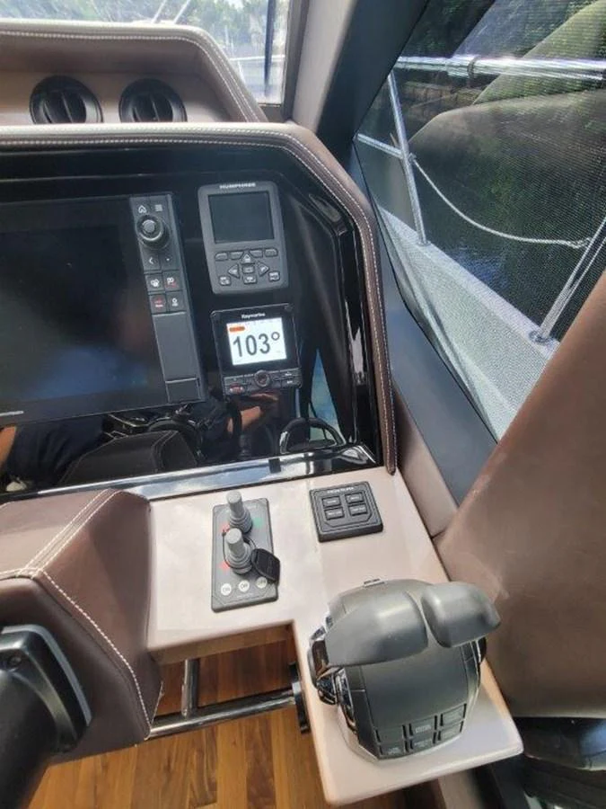 The helm station features advanced navigation equipment and controls for a seamless sailing experience. aboard GODSPEED Yacht for Sale