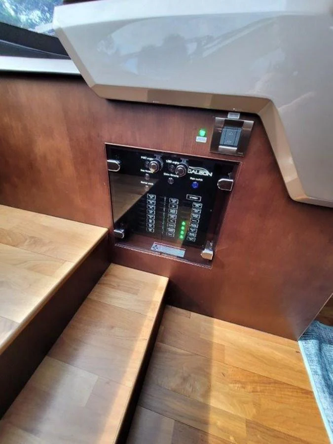 A close-up view of the yacht's control panel and wooden steps. aboard GODSPEED Yacht for Sale