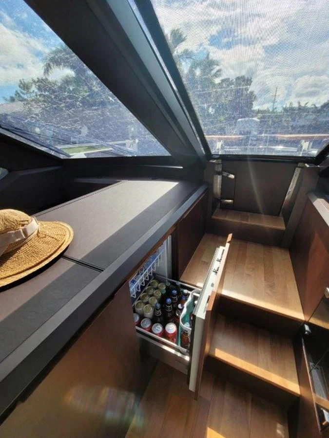 A modern yacht galley with a skylight and a well-stocked refrigerator. aboard GODSPEED Yacht for Sale