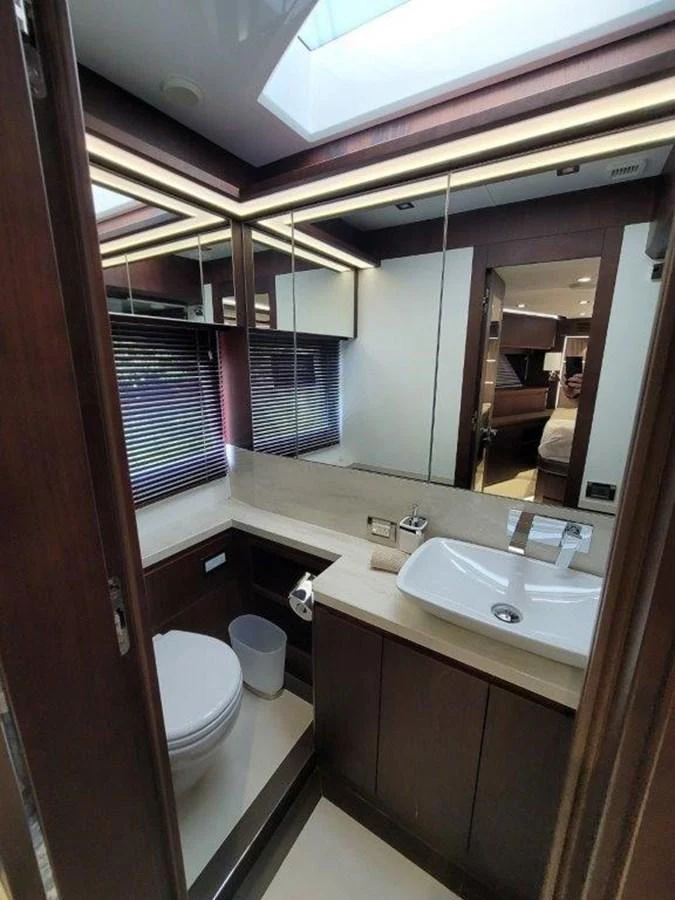 The yacht's bathroom features a sleek design with modern fixtures and ample lighting. aboard GODSPEED Yacht for Sale