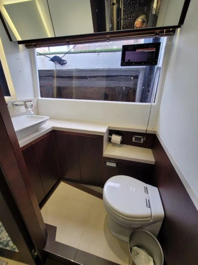 A compact and modern yacht bathroom with a sleek design. aboard GODSPEED Yacht for Sale