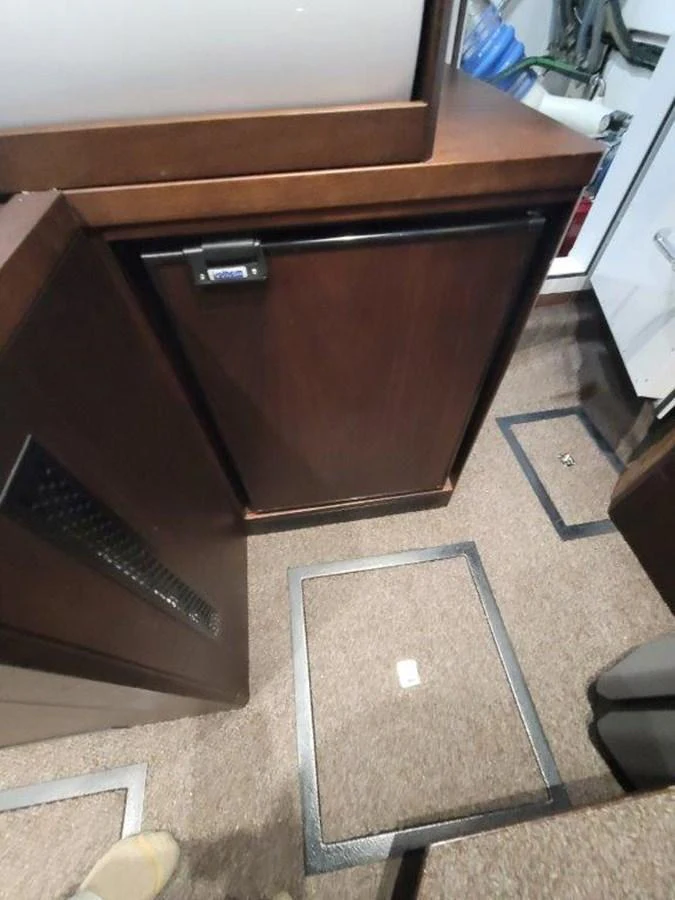 The image shows a section of the yacht's interior with a focus on cabinetry and flooring. aboard GODSPEED Yacht for Sale
