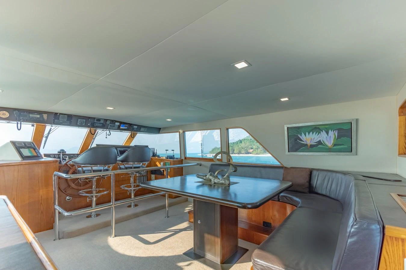 a room with a table and couch aboard NYMPHAEA Yacht for Sale