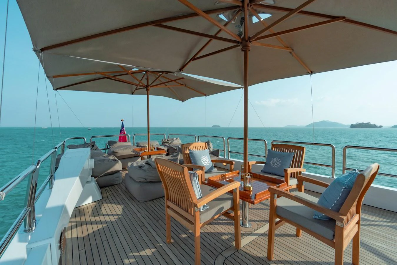 a deck with chairs and umbrellas on it aboard NYMPHAEA Yacht for Sale