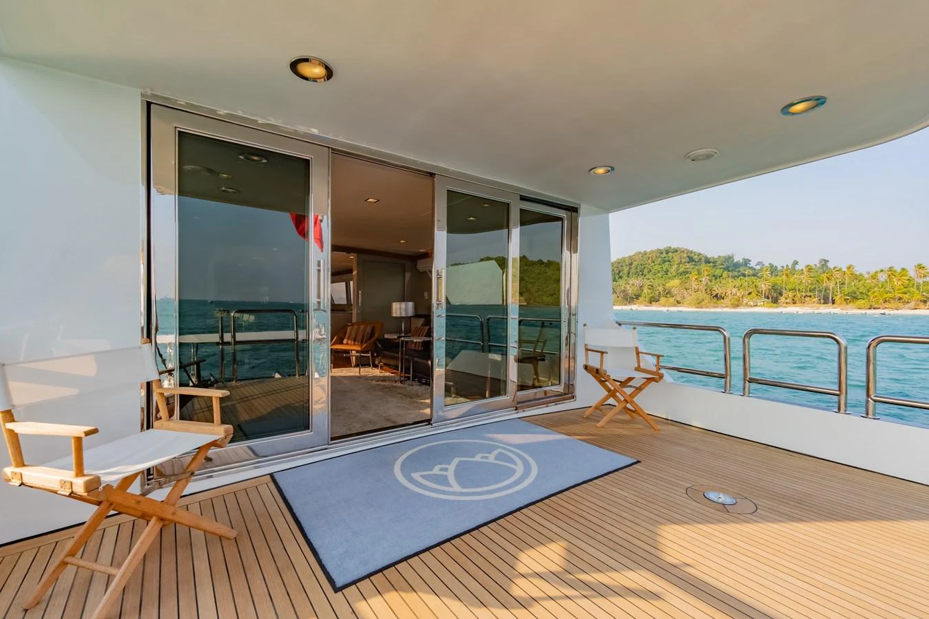a large swimming pool with a large glass door and a deck with a view of the water and aboard NYMPHAEA Yacht for Sale