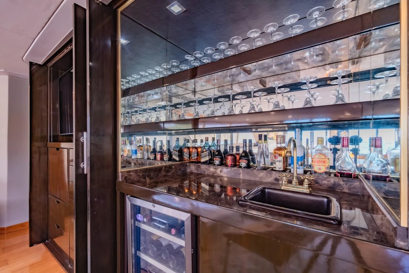 a kitchen with a large glass display case aboard NYMPHAEA Yacht for Sale