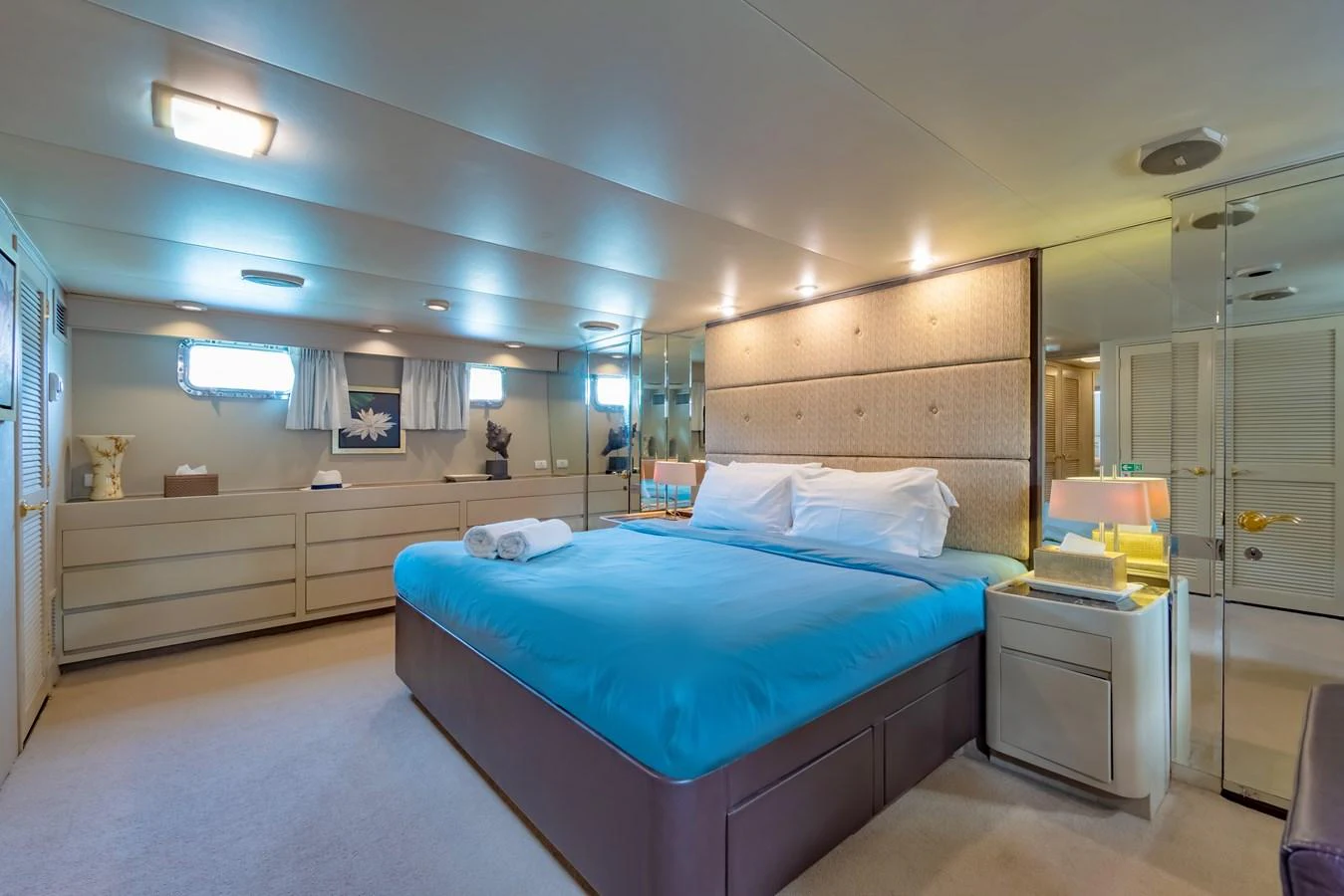 a bedroom with a bed and a desk aboard NYMPHAEA Yacht for Sale