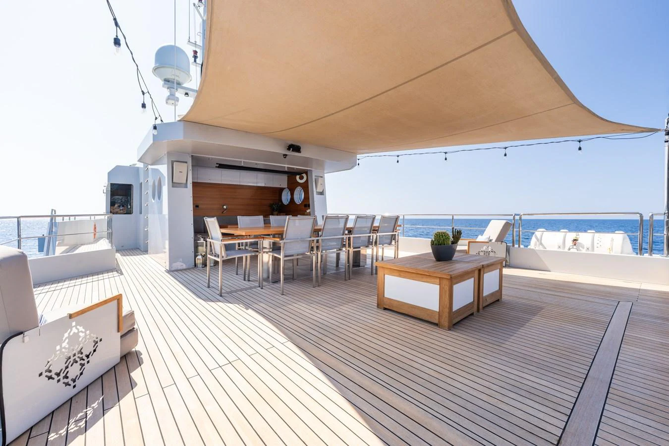 a room with a wood table and chairs and a large window aboard PREFERENCE 19 Yacht for Sale