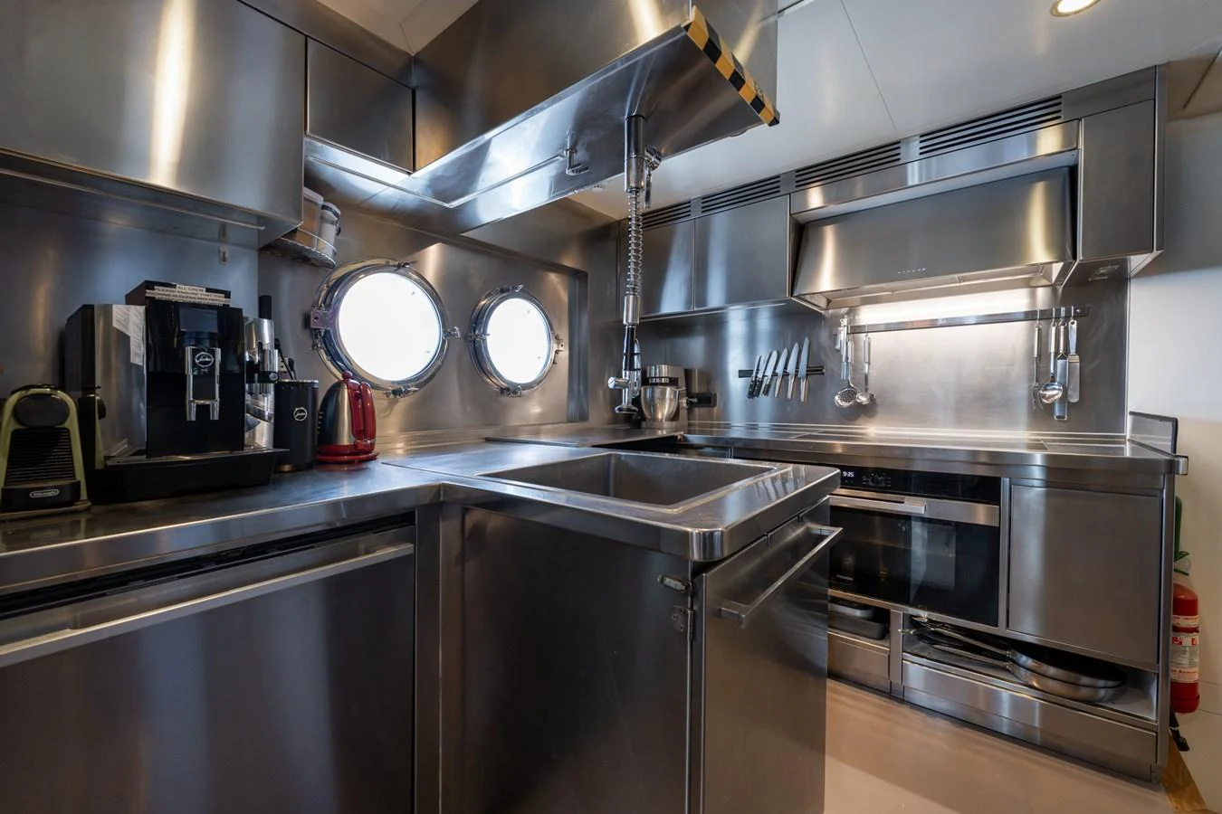 a kitchen with stainless steel appliances aboard PREFERENCE 19 Yacht for Sale