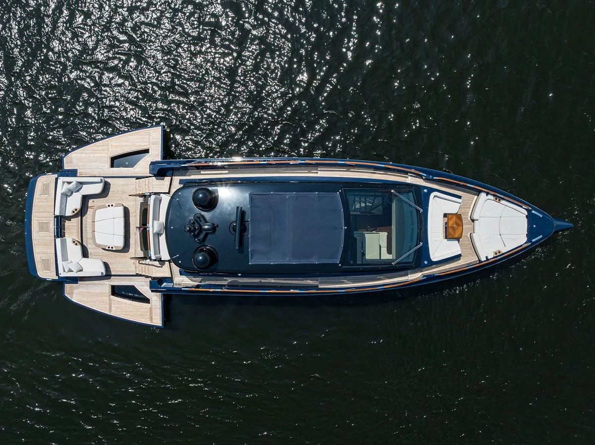 An aerial view of a sleek yacht cruising on the water, showcasing its elegant design and spacious deck areas. aboard LAZZARA LSX 67 Yacht for Sale