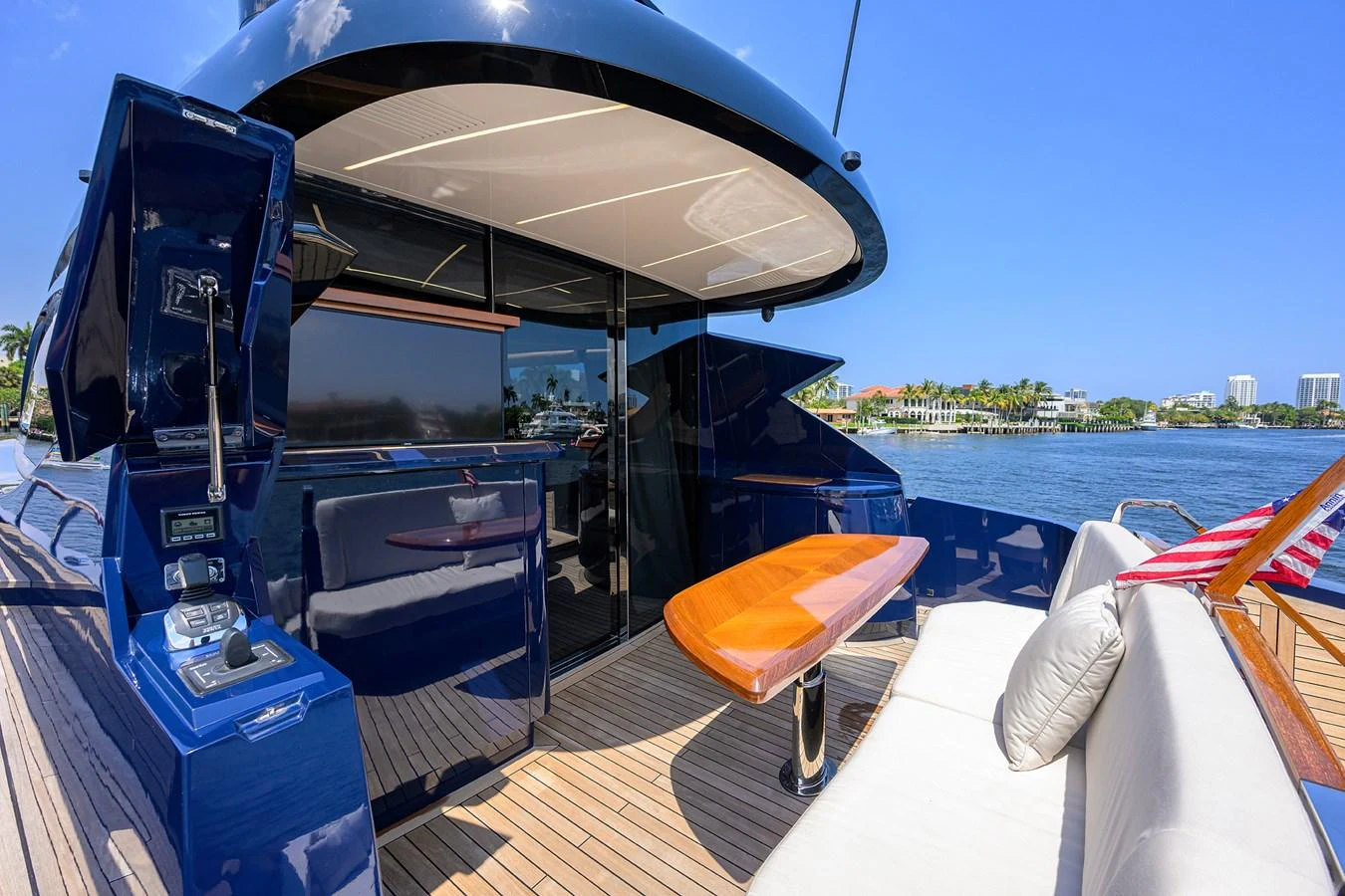The aft deck features a comfortable seating area and a sleek table, perfect for outdoor relaxation. aboard LAZZARA LSX 67 Yacht for Sale