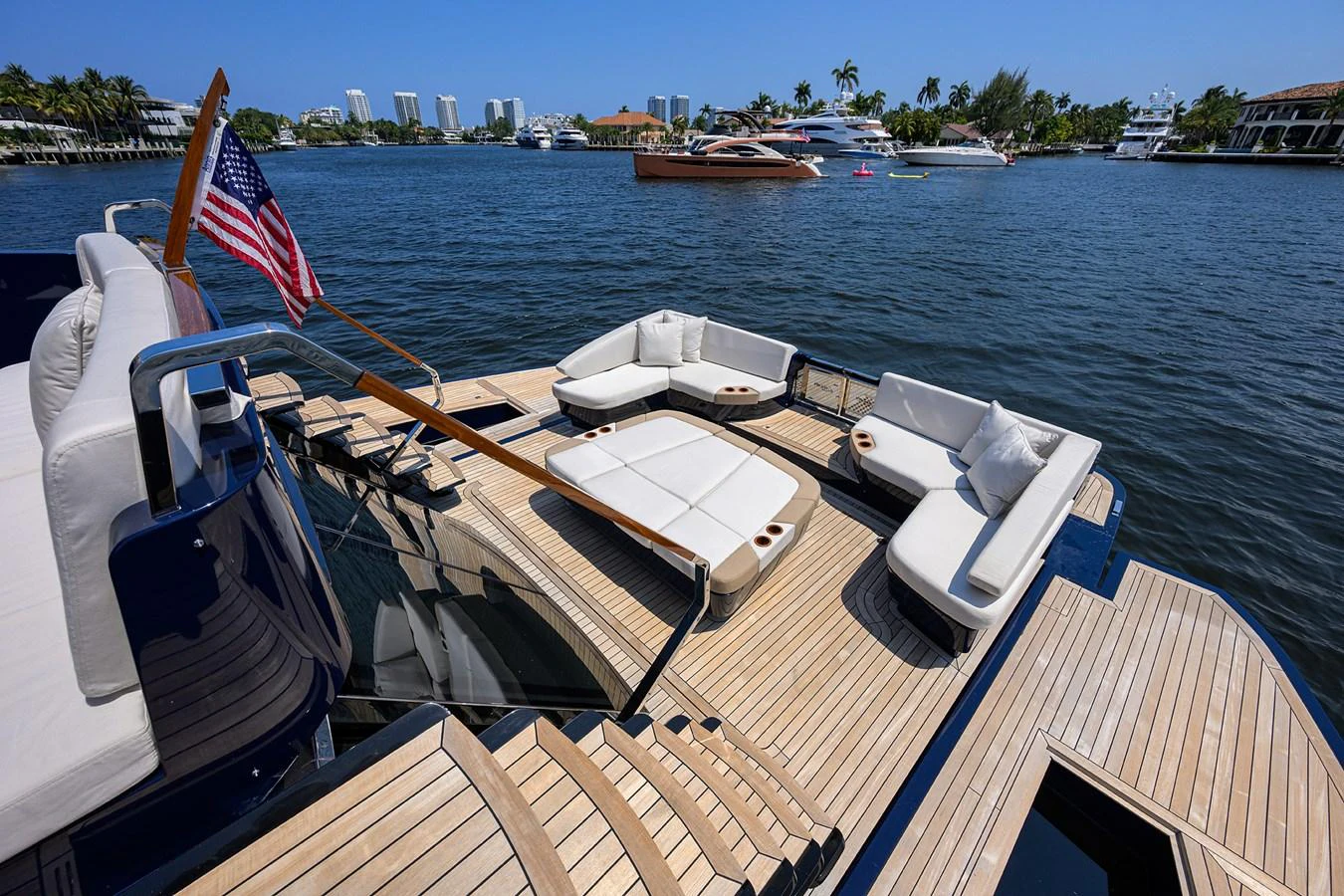 The yacht's aft deck features luxurious seating with a stunning waterfront view. aboard LAZZARA LSX 67 Yacht for Sale