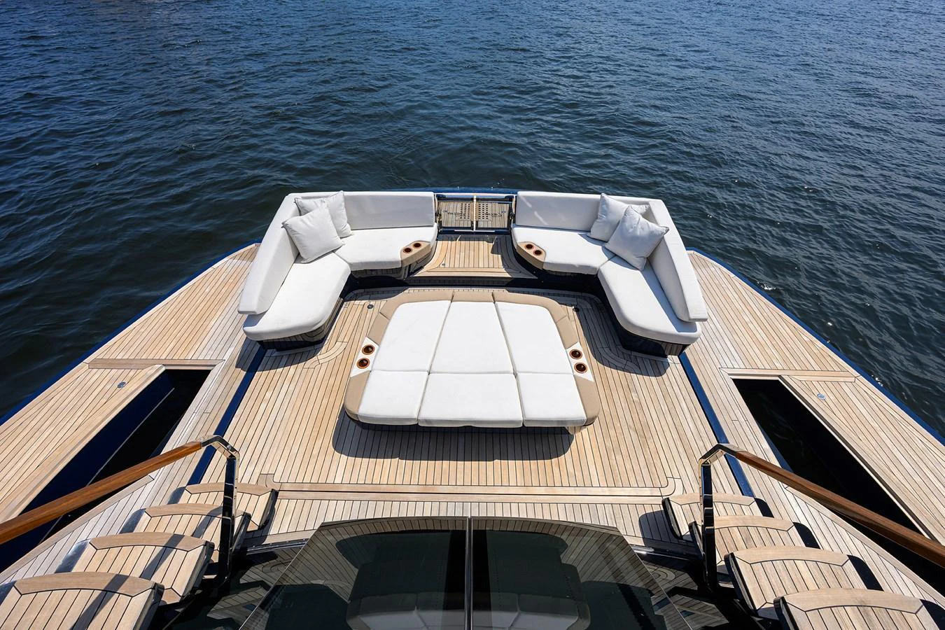 The yacht's aft deck features a spacious seating area with luxurious cushions and a stunning view of the water. aboard LAZZARA LSX 67 Yacht for Sale